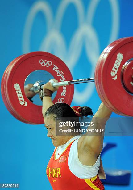 Cao Lei of China sets a new Olympic record in the snatch, lifting 128 kg in the women's 75 kg weightlifting event during the 2008 Beijing Olympic...