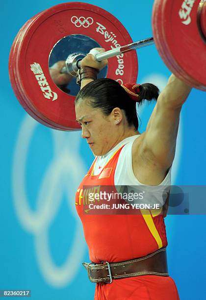 Cao Lei of China sets a new Olympic record in the snatch, lifting 128 kg in the women's 75 kg weightlifting event during the 2008 Beijing Olympic...