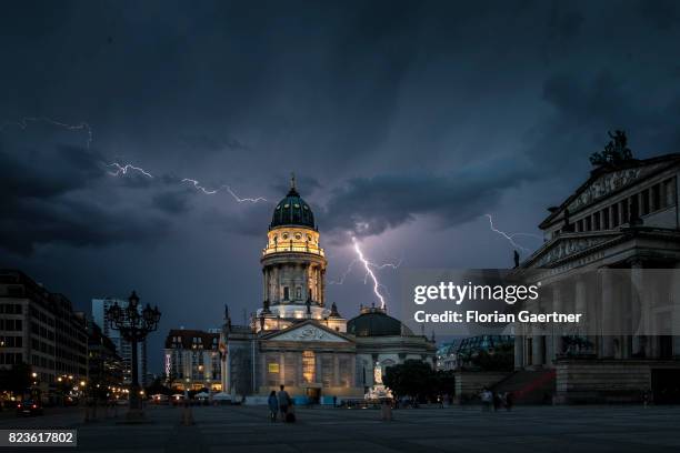 Lightning strikes behind the German Chruch and the Konzerthaus at the Gendarmenmarkt on July 27, 2017 in Berlin, Germany.