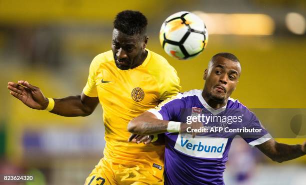 Limassol's Kevin Lafrance jumps for the ball with Austria Wien's Felipe Pires during a UEFA Europa League qualifying football match between FK...