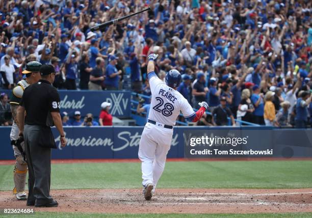 Steve Pearce of the Toronto Blue Jays flips his bat after hitting a game-winning grand slam home run in the tenth inning during MLB game action...