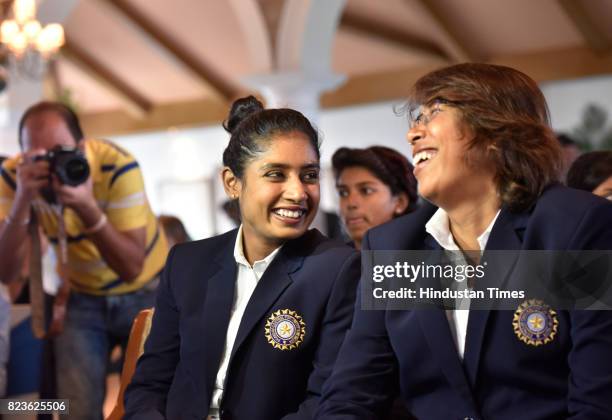 Indian Women's Cricket team captain Mithali Raj shares light moment with teammate Jhulan Goswami during the felicitating event on July 27, 2017 in...