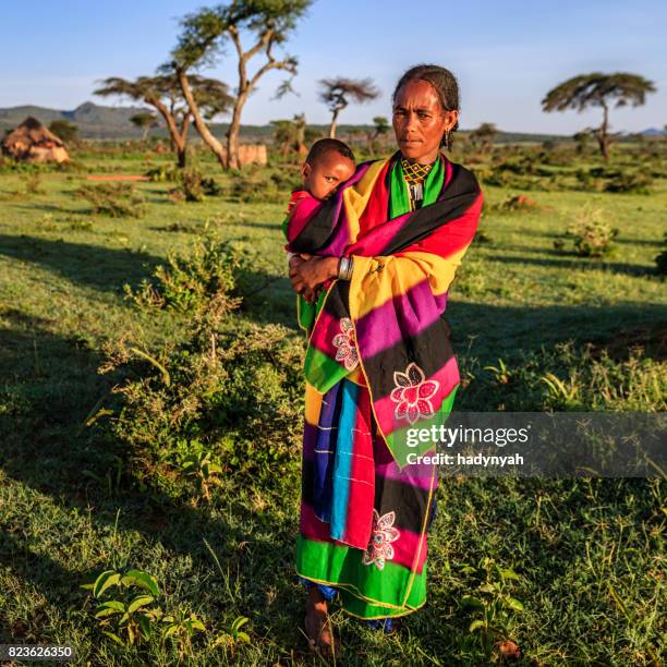 woman from borana tribe holding her baby, ethiopia, africa - borana stock pictures, royalty-free photos & images