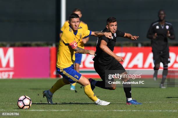 Luca Marrone of Juventus second team competes with Claudio Morra of Pro Vercelli during the joint training Juventus second team v Pro Vercelli on...