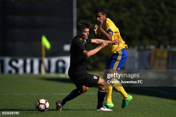 Rogerio of Juventus second team competes with Filippo Berra of Pro Vercelli during the joint training Juventus second team v Pro Vercelli on July 27,...
