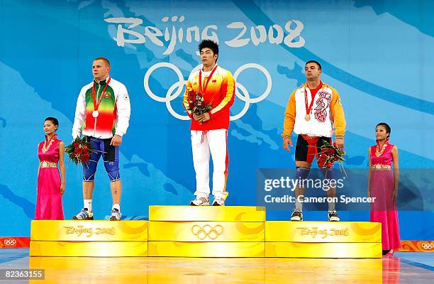 Silver medal winner Andrei Rybakou of Belarus, gold medal winner Lu Yong of China and bronze medal winner Tigran Martirosyan of Armenia wave to the...