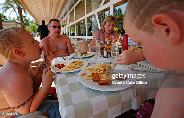 The Kerr family from Northern Ireland enjoy their lunch while on holiday at the Costa Encantada hotel on August 15, 2008 in Lloret de Mar, Spain....