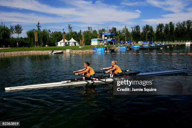 Amber Halliday and Marguerite Houston of Australia row to the start of the Women's Doubles Sculling at the Shunyi Olympic Rowing-Canoeing Park during...