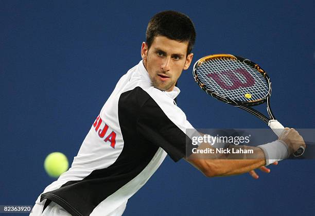 Novak Djokovic of Serbia returns to Rafael Nadal of Spain in the men's semifinal tennis match at the Olympic Green Tennis Center on Day 7 of the...