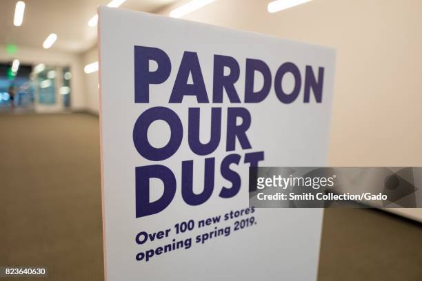 Signage reading "Pardon Our Dust" and announcing the opening of 100 new stores in 2019 during a renovation at the Westfield Valley Fair shopping mall...