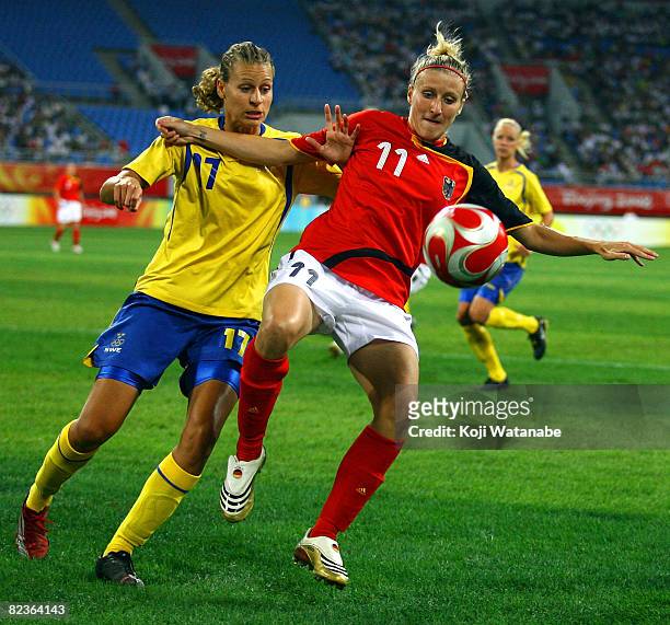 Anja Mittag of Germany and Charlotte Rohlin of Sweden compete for the ball during the Women's Quarter Final match between Sweden and Germany at...