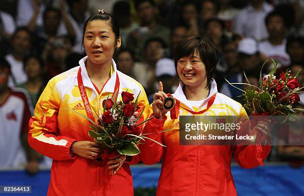 Bronze medalists Wei Yili and Zhang Yawen of China celebrate after the Women's Doubles at the Beijing University of Technology Gymnasium on Day 7 of...