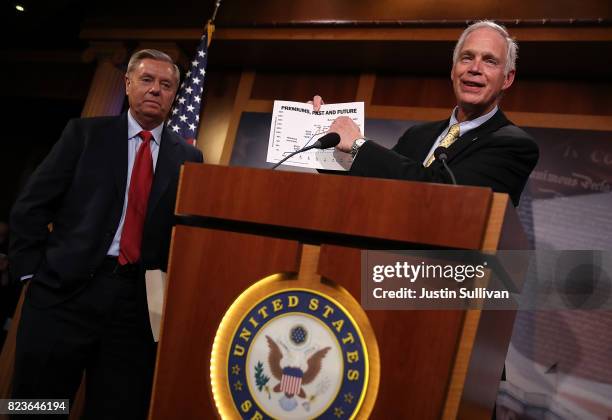 Sen. Lindsey Graham looks on as Sen. Ron Johnson speaks during a news conference to announce opposition to the so-called skinny repeal of Obamacare...