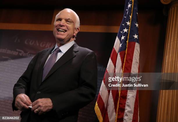 Sen. John McCain laughs during a news conference to announce opposition to the so-called skinny repeal of Obamacare at the U.S. Capitol July 27, 2017...