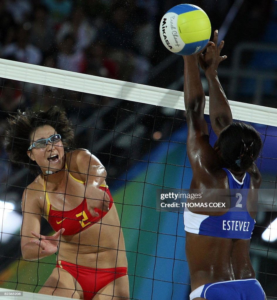 China's Zhang Xi (L) smashes the ball ag