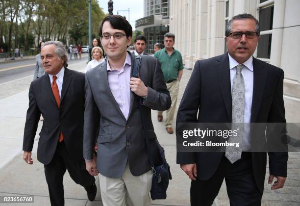 Martin Shkreli, former chief executive officer of Turing Pharmaceuticals AG, center, exits federal court with his attorney Benjamin Brafman, left, in...