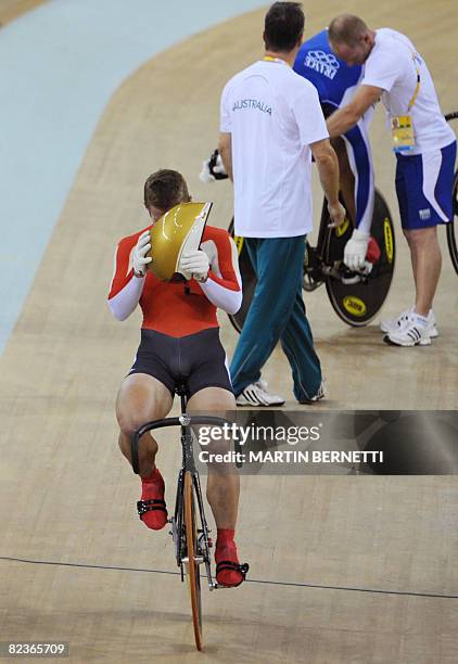 Germany's Rene Enders cries after arriving in third place in the 2008 Beijing Olympic Games men's cycling team sprint final at the Laoshan Velodrome...