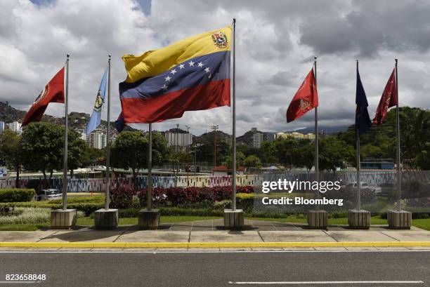 Venezuelan flag flies outside the Ministry of Defense building in Caracas, Venezuela, on Thursday, July 27, 2017. U.S. Sanctions against 13 officials...