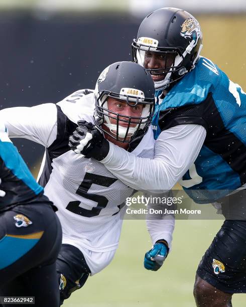 Linebacker Paul Posluszny is blocked by Tackle Brandon Albert of the Jacksonville Jaguars works out during Training Camp at Florida Blue Health and...