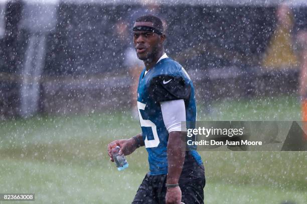 Wide Receiver Allen Robinson of the Jacksonville Jaguars walks off the field through the rain holding a Gatorade Bottle after Training Camp at...