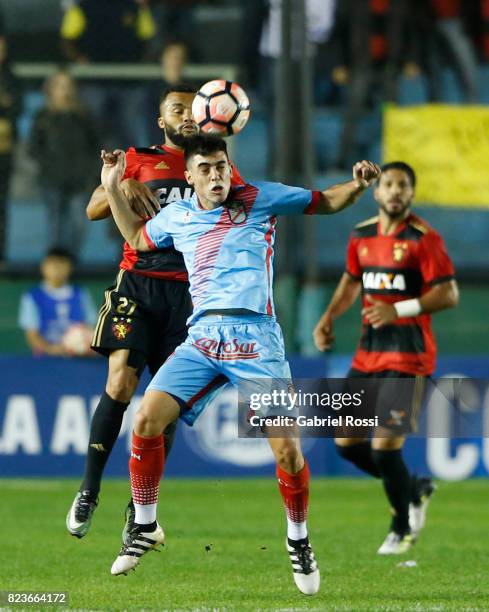 Samuel Xavier of Sport Recife fights for the ball with Juan Brunetta of Arsenal during a second leg match between Arsenal and Sport Recife as part of...