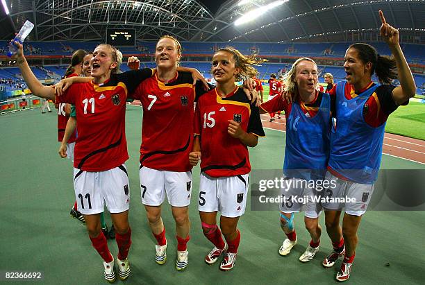 Anja Mittag, Melanie Behringer, Fatmire Bajramaj, Conny Pohlers and Celia Okoyino Da Mbabi of Germany celebrate their win over Sweden after the...