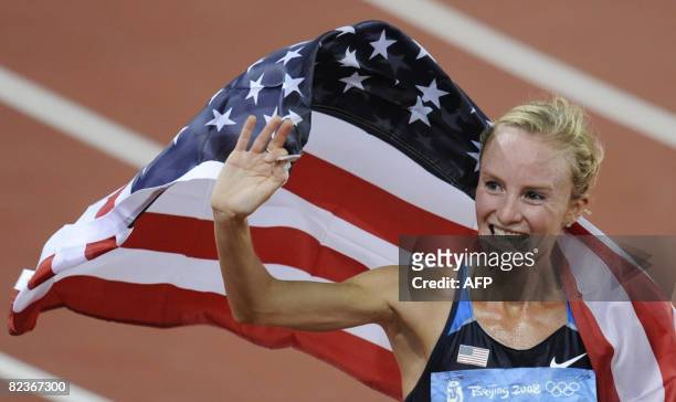 Shalane Flanagan of the US waves to supporters as she celebrates placing third in the women's 10,000m final at the National stadium as part of the...