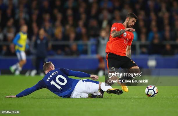 Erik Daniel of MFK Ruzomberok is tackled by Wayne Rooney of Everton during the UEFA Europa League Third Qualifying Round, First Leg match between...