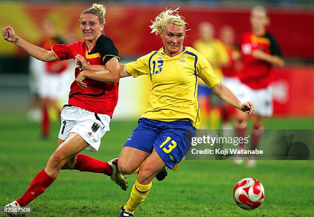 Frida Ostberg of Sweden and Anja Mittag of Germany compete for the ball during the Women's Quarter Final match between Sweden and Germany at Shenyang...