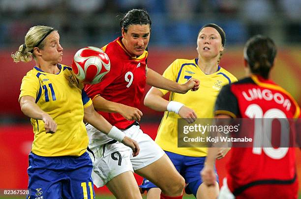 Birgit Prinz of Germany and Victoria Svensson of Sweden compete for the ball during the Women's Quarter Final match between Sweden and Germany at...