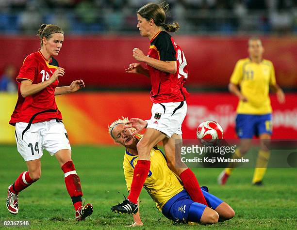 Caroline Seger of Sweden and Kerstin Garefrekes of Germany compete for the ball during the Women's Quarter Final match between Sweden and Germany at...