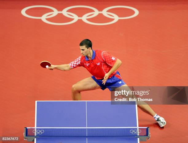 Andrej Gacina of Croatia in action against Werner Schlager of Austria during their Men's Team Bronze Play-off Round 1 match at the Peking University...