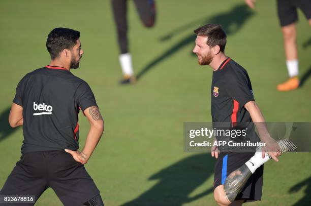 Barcelona players Lionel Messi and Luis Suarez take part in a training session at Barry University in Miami, Florida, on July 27 two days before...