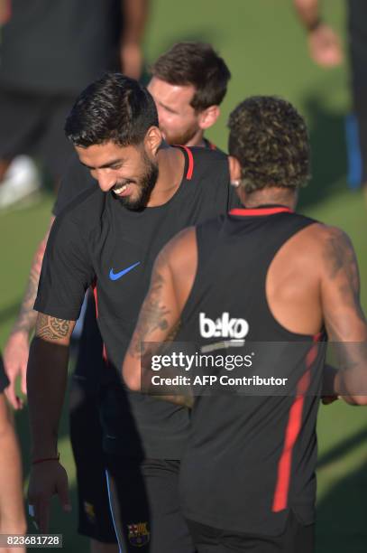 Barcelona player Luis Suarez jokes during a training session at Barry University in Miami, Florida, on July 27 two days before their International...