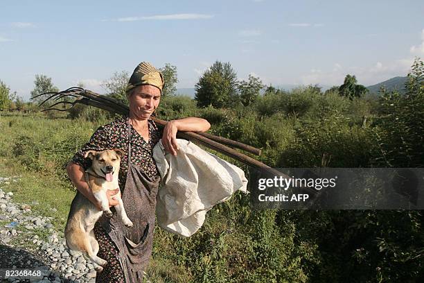 North Ossetian woman carries a dog in Allagir, near to border between Russia and South Ossetia, on August 15, 2008. Chaos reigned in Gori as Russian...