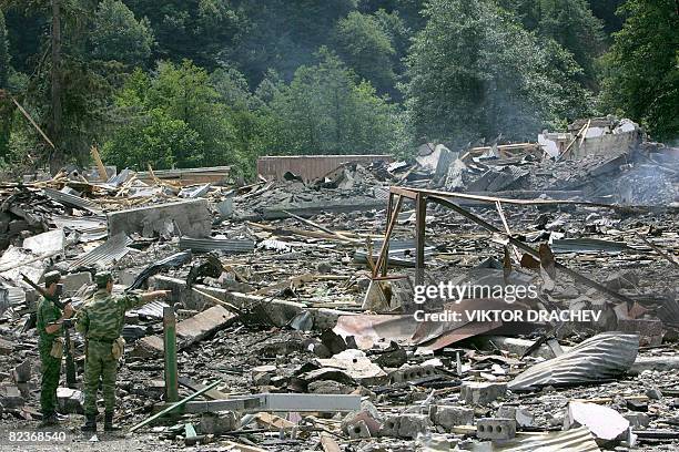 Abhazian soldiers examine the site of a former Georgian weapons depot 100km east of Sukhumi, in the town Adzhara, on August 15, 2008 in the remote...