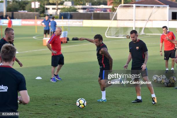 Barcelona player Neymar and teammates take part in a training session at Barry University in Miami, Florida, on July 27 two days before their...