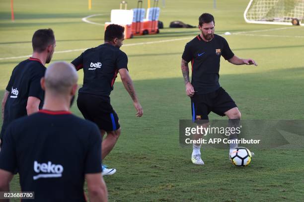 Barcelona player Lionel Messi and teammates take part in a training session at Barry University in Miami, Florida, on July 27 two days before their...