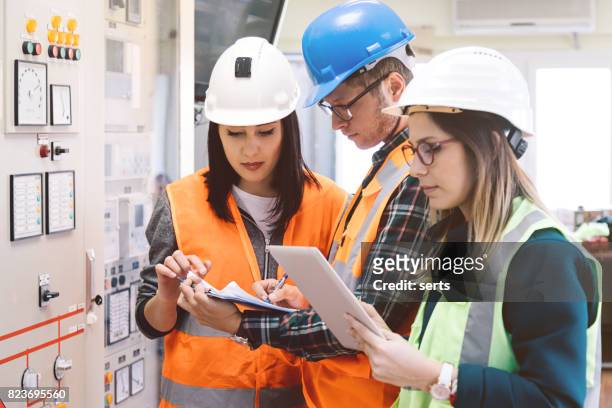 young maintenance engineer team working at energy control room - electrical fuse box stock pictures, royalty-free photos & images