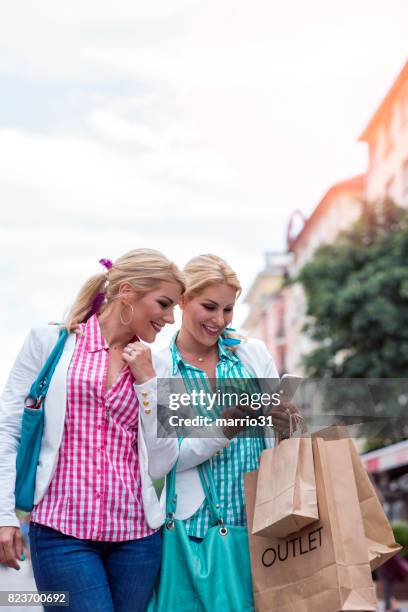 shopping and looking at smart phone - outlet store stock pictures, royalty-free photos & images