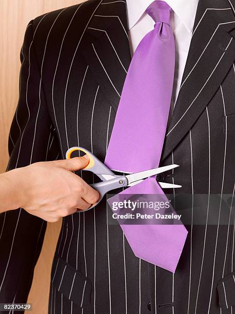 businessman having tie cut off - business revenge stock pictures, royalty-free photos & images