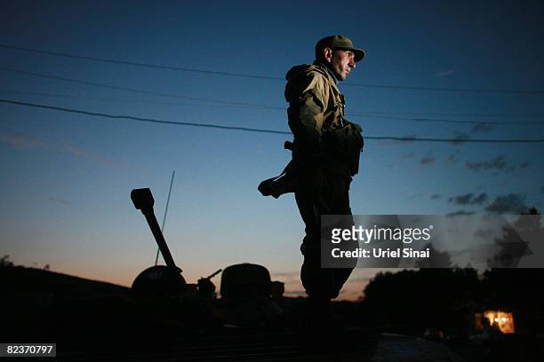 Russian soldier looks on as a convoy of Russian armour arrives a securing point as the tense standoff on the north of Georgia continued on August 15,...