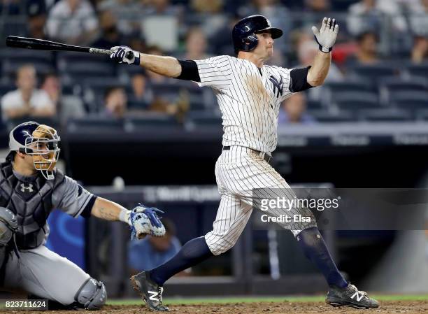 Brett Gardner of the New York Yankees hits a solo home run in the 11th inning as Wilson Ramos of the Tampa Bay Rays defends on July 27, 2017 at...