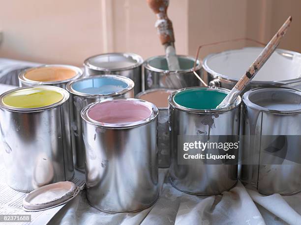 different coloured paint pots with lids off - ペンキ缶 ストックフォトと画像
