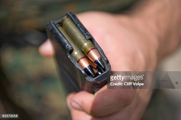 Georgian special forces soldier holds a magazine of specialized subsonic armor-piercing bullets designed to be fired through a silenced rifle August...