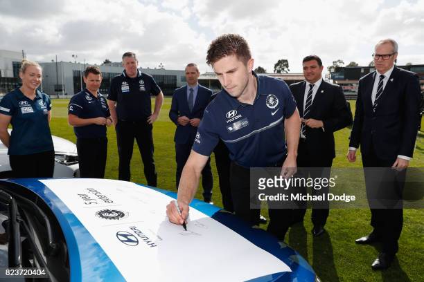 Blues Captain Marc Murphy signs a Hyundai car after the club signed a new five year sponsor agreement with the car maker during a Carlton Blues AFL...