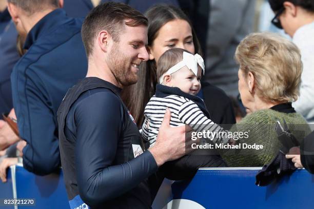 Sam Docherty of the Blues holds a baby during a Carlton Blues AFL training session at Visy Park on July 28, 2017 in Melbourne, Australia.