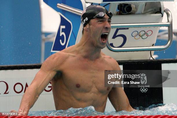 Michael Phelps of the United States celebrates victory in the Men's 100m Butterfly Final held at the National Aquatics Centre during Day 8 of the...