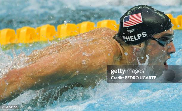 Swimmer Michael Phelps competes in the men's 100m butterfly swimming final at the National Aquatics Center during the 2008 Beijing Olympic Games in...