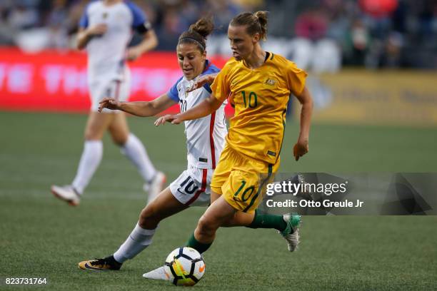 Emily Van Egmond of Australia dribbles against Carli Lloyd of the United States during the 2017 Tournament of Nations at CenturyLink Field on July...